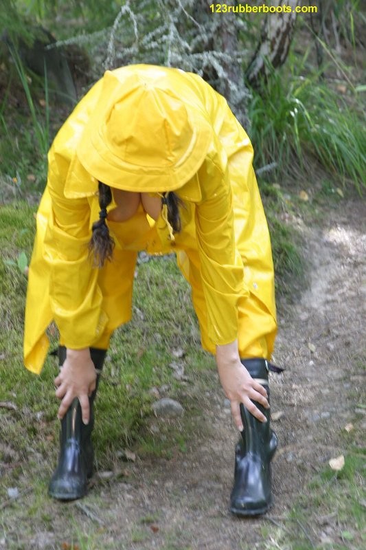 Sexy girl with rubber boots and yellow rainwear #73286124