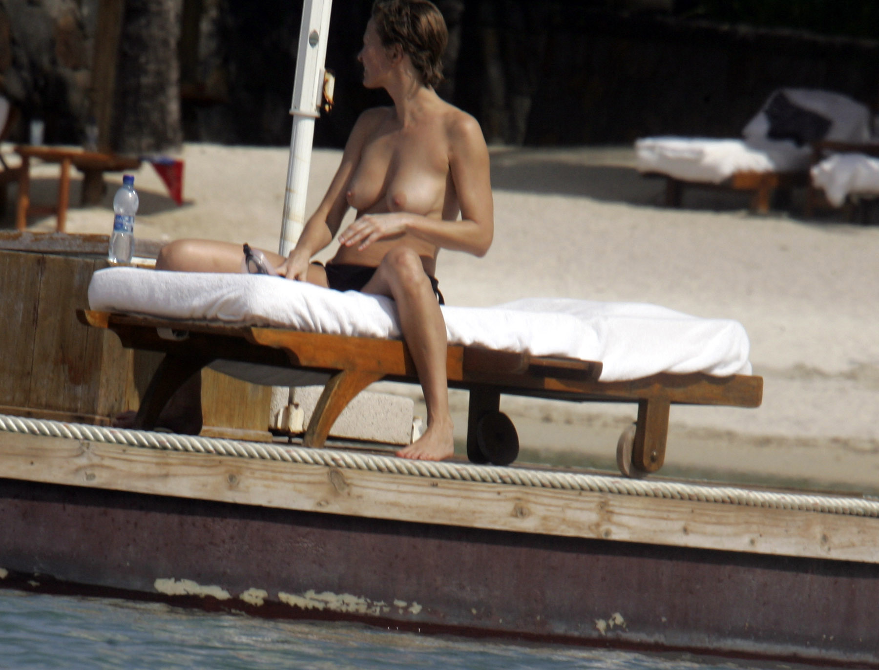 Karen Mulder tanning topless on a beach in Mauritius #75276599