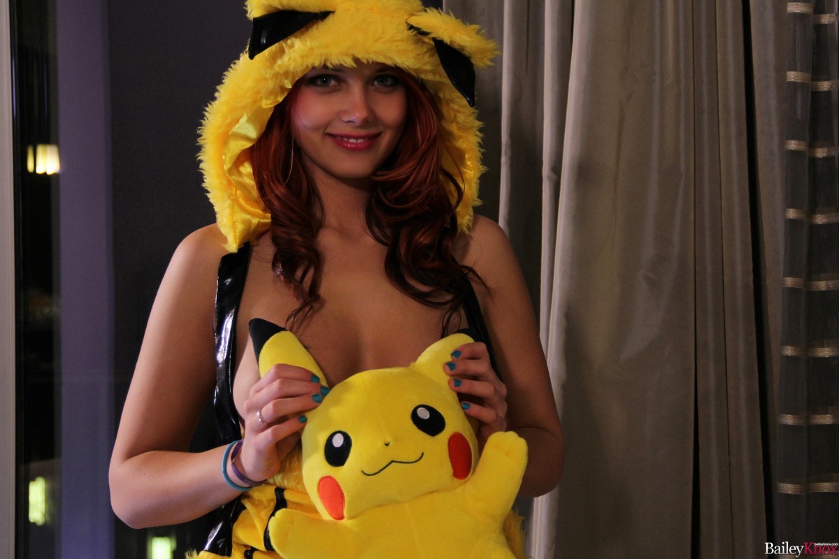 Cute teen posing with a Pikachu doll #70830675