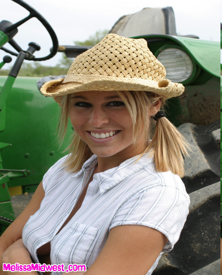 Melissa Midwest on the farm next to a tractor #67450723