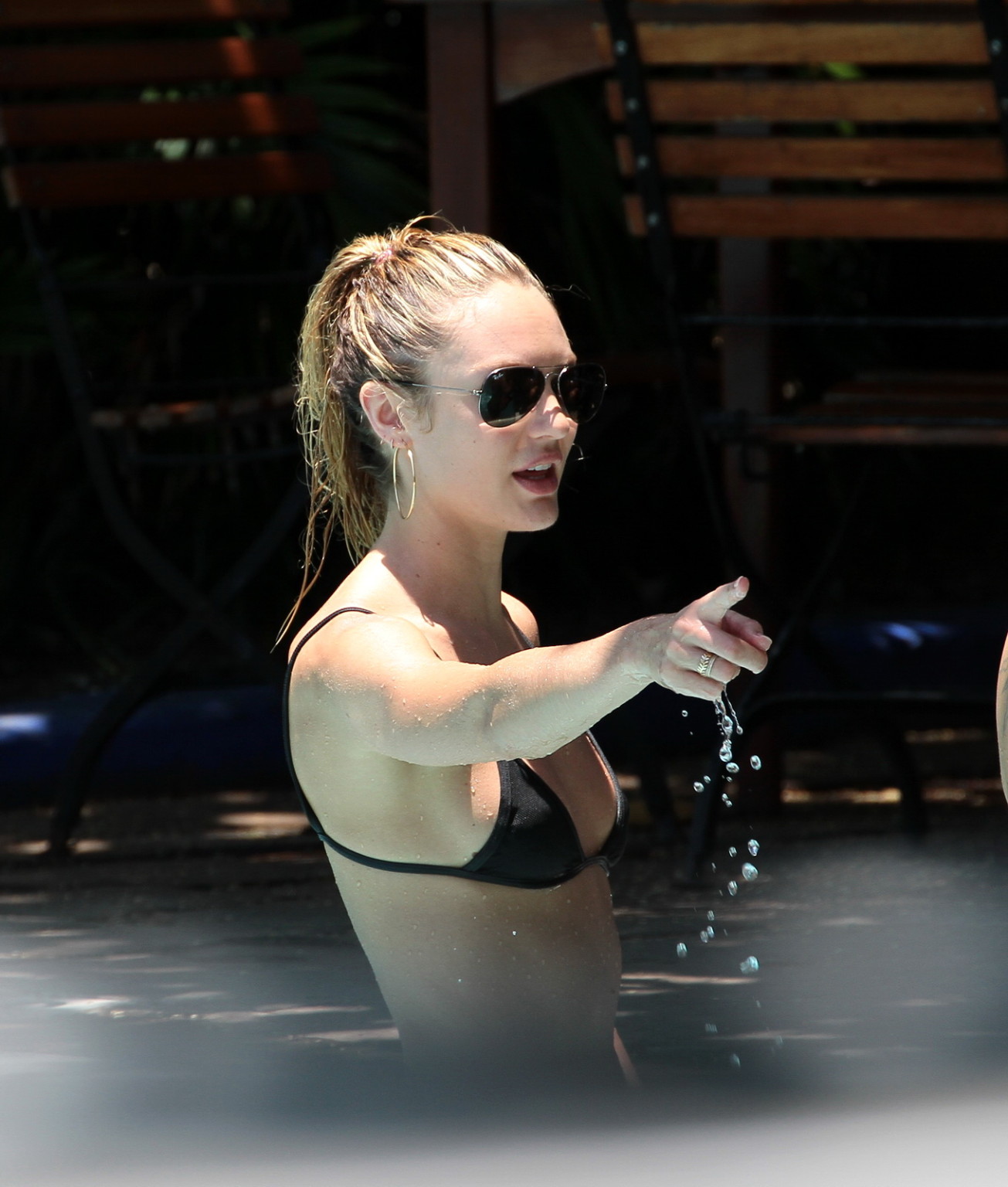 Candice Swanepoel in sexy black bikini petting with her boyfriend at the pool in #75231145