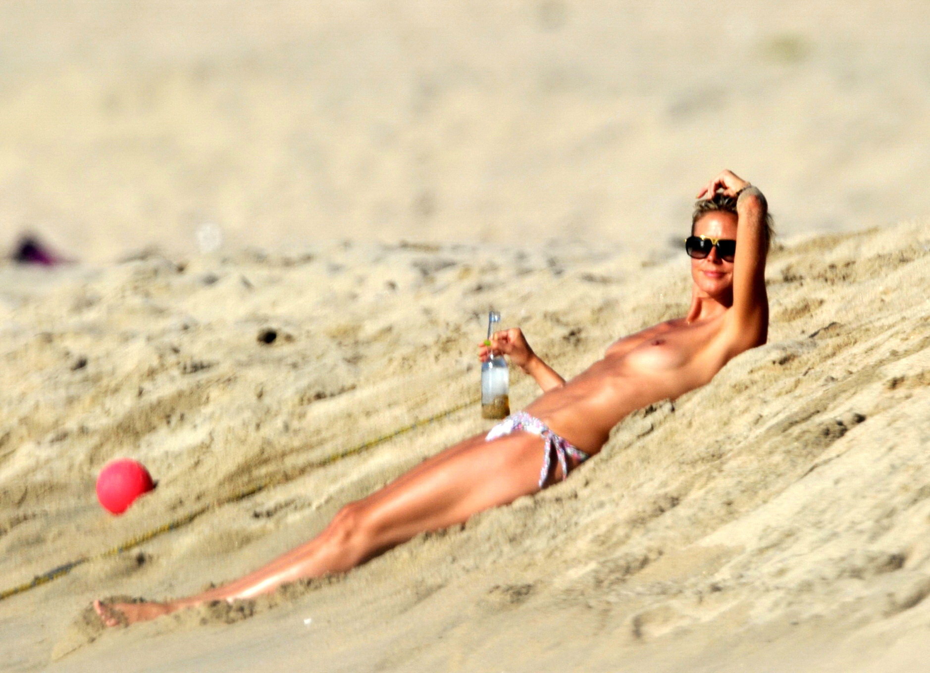 Heidi Klum tanning topless on a sandy beach in Corsica #75293296