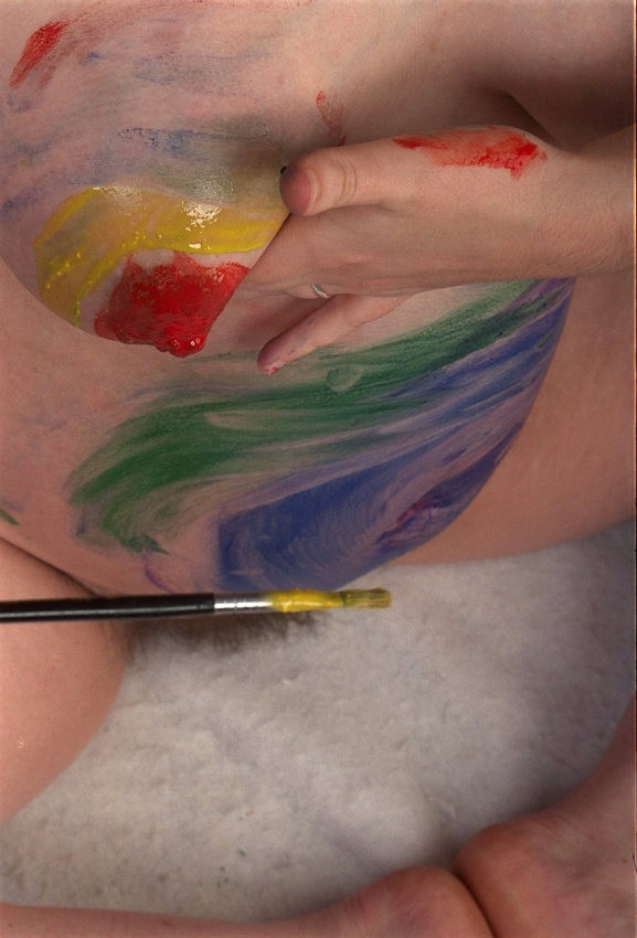 Pregnant beauty painting her body #76632870