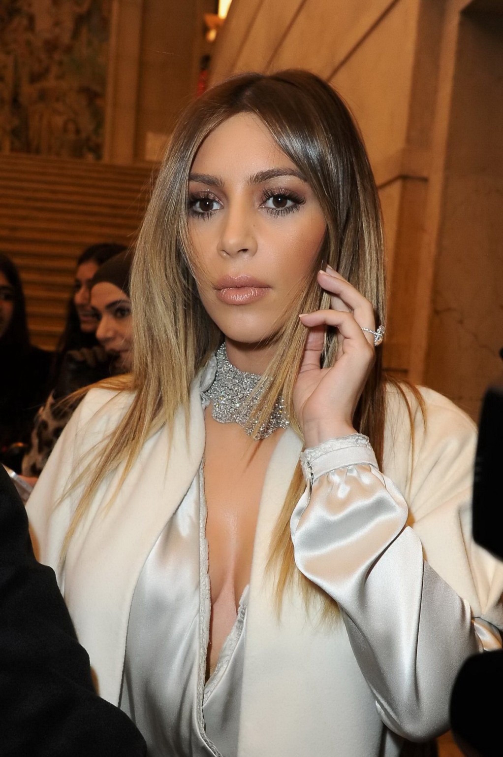Kim Kardashian cleavy wearing low cut white satin gown at Stephane Rolland's fas