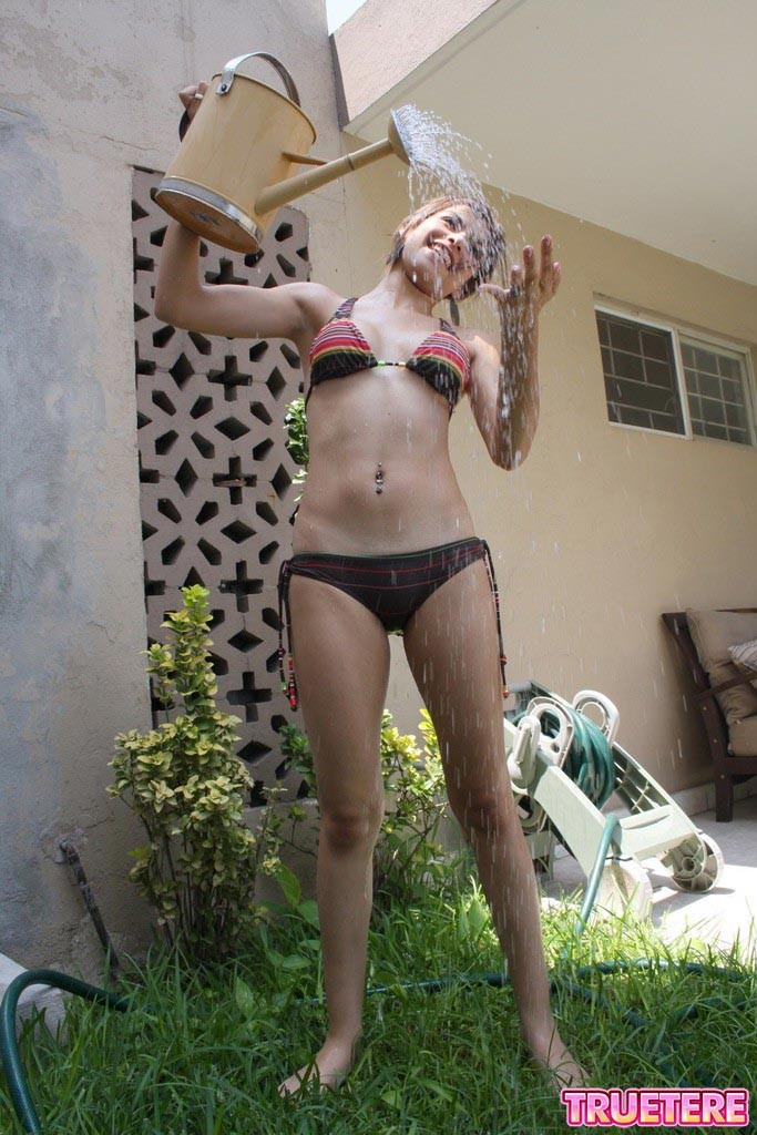 Teen girl in bikini gets wet outside #73174663