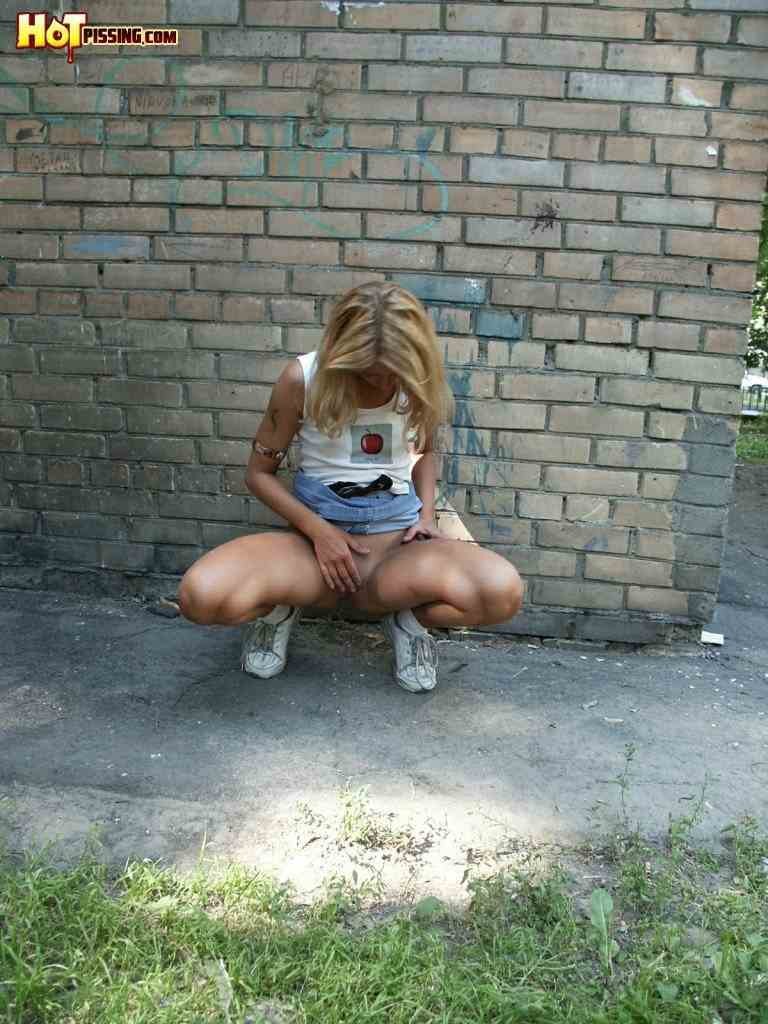 Cute girl pissing on the side walk #76593232