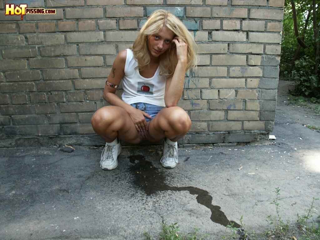 Cute girl pissing on the side walk #76593312