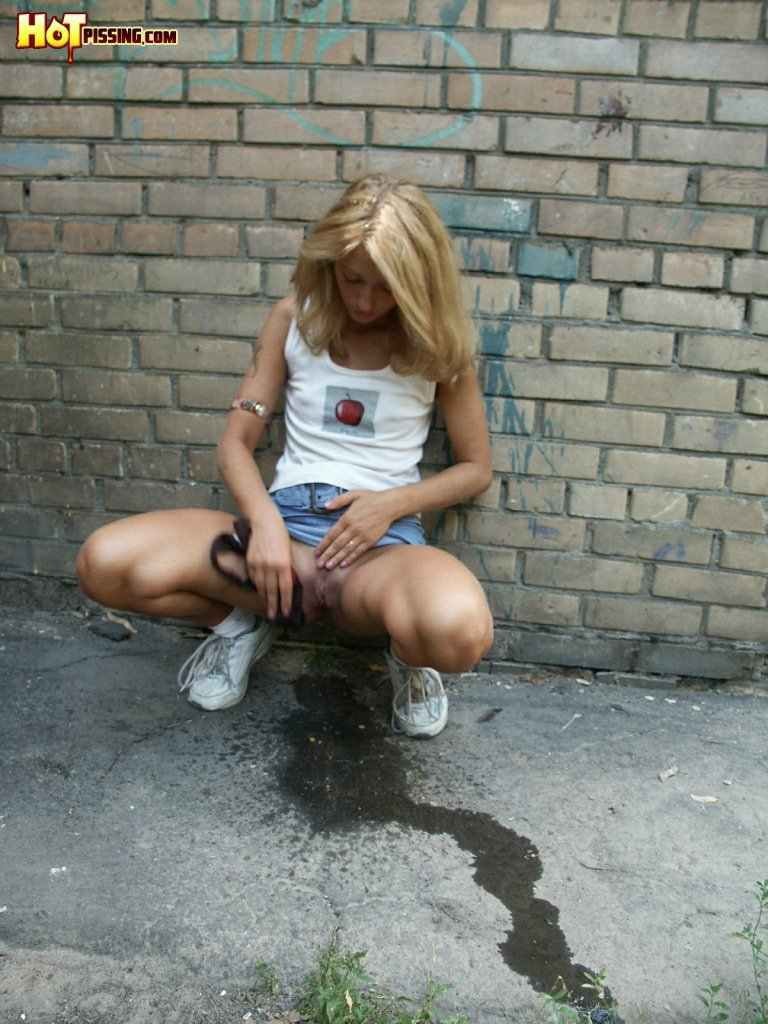 Cute girl pissing on the side walk #76593326