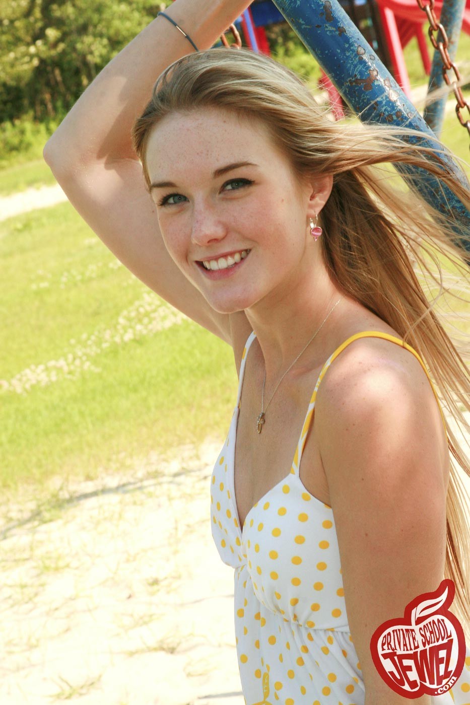 Cute blonde teen girl swinging outdoors #73530494