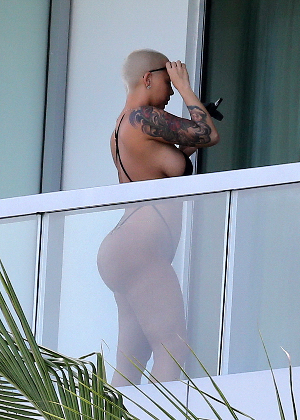 Amber Rose shows off her round ass wearing a tiny black monokini on a hotel balc #75174854