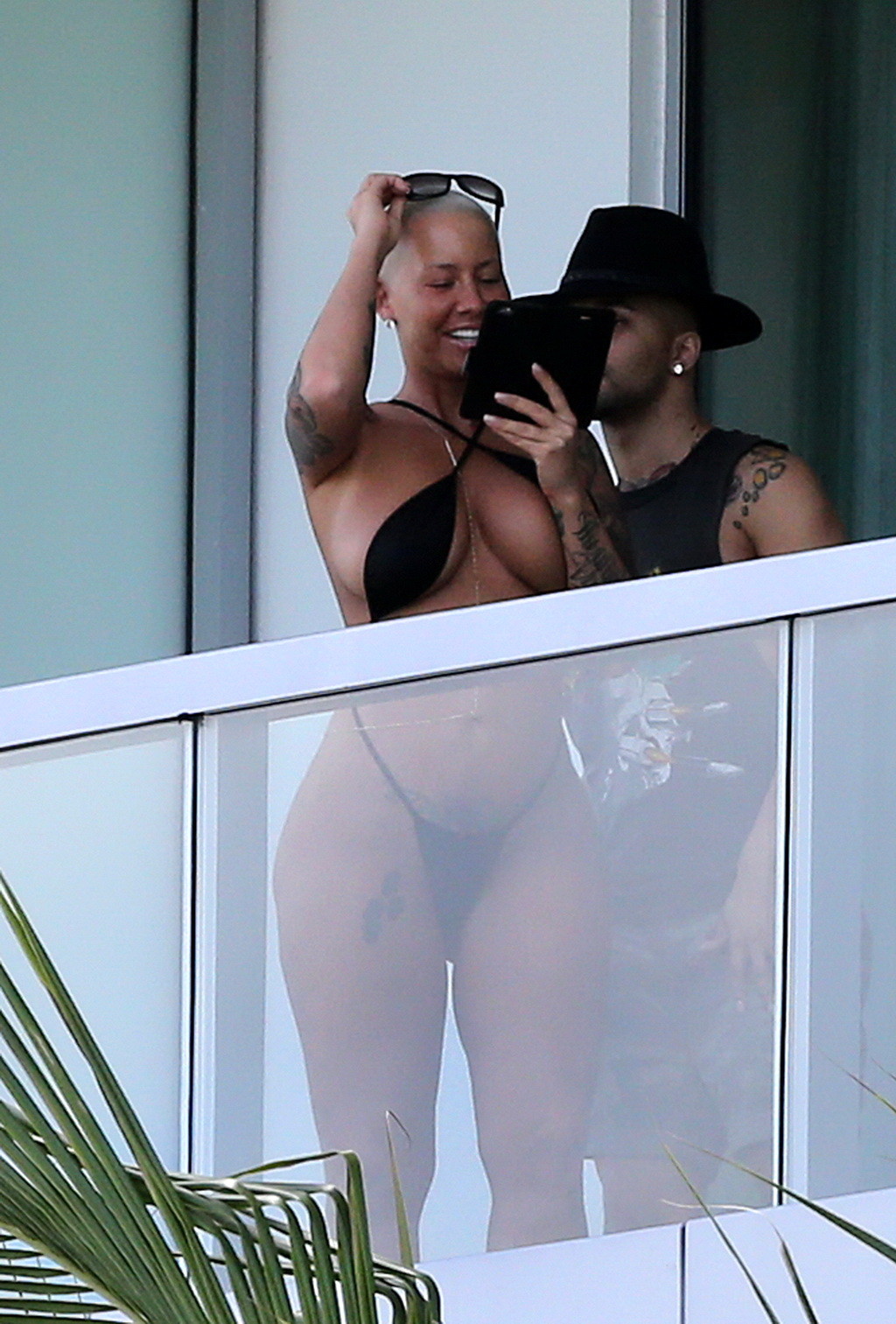 Amber Rose shows off her round ass wearing a tiny black monokini on a hotel balc #75174914