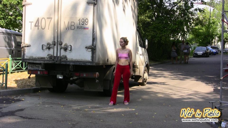 Cutie hides behind a truck to pee right through her red sporty pants #73239849