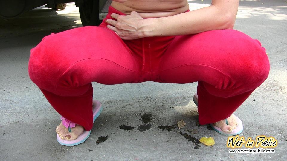 Cutie hides behind a truck to pee right through her red sporty pants #73239876