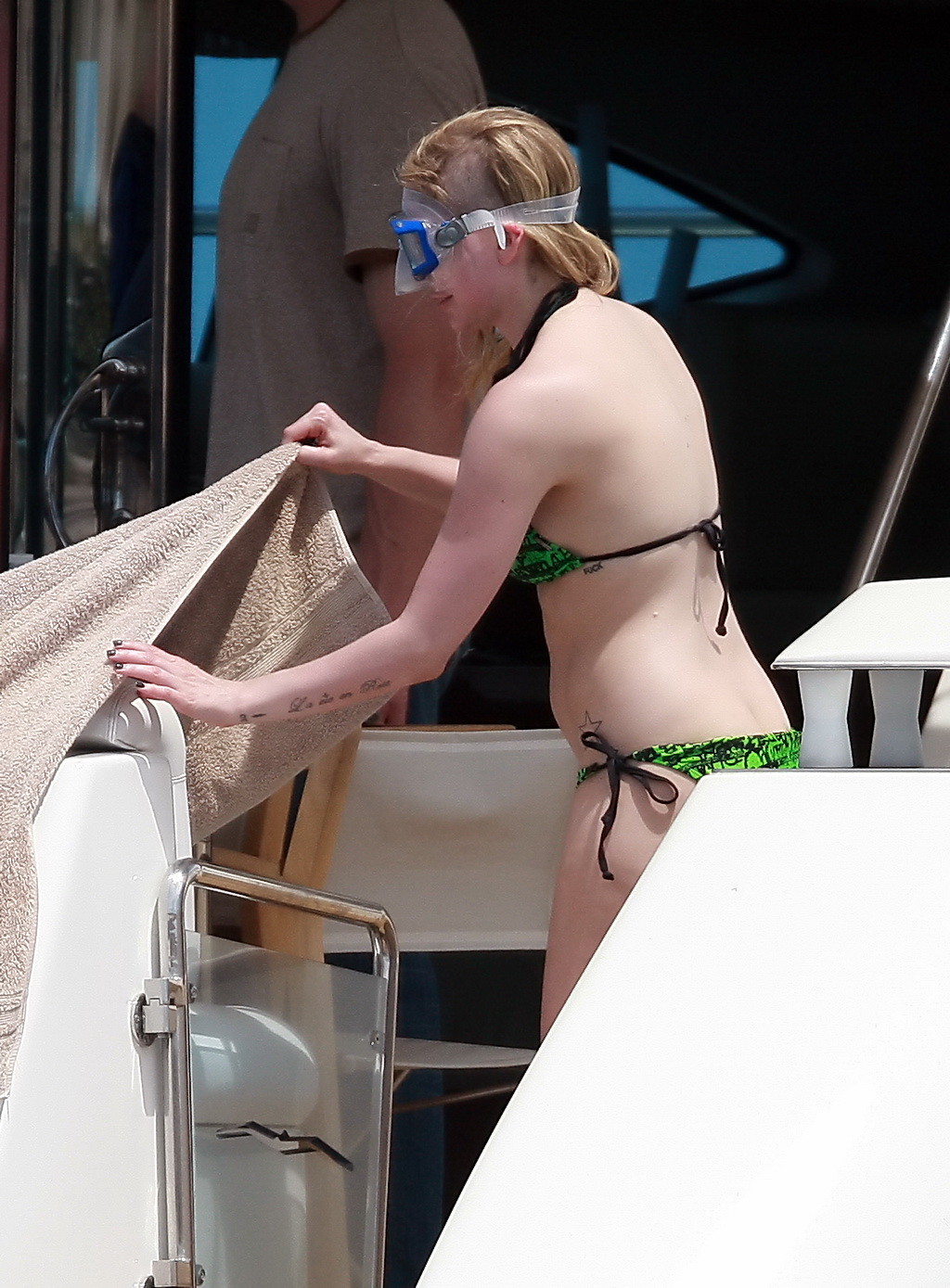 Avril Lavigne showing off her curvy body wearing skimpy green bikini while scuba