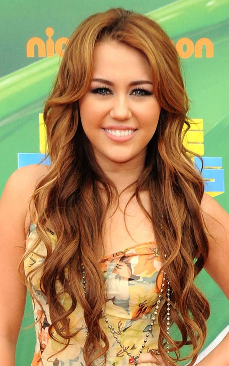 Miley Cyrus big cleavage in underwear and looking sexy in colorfull dress #75309527