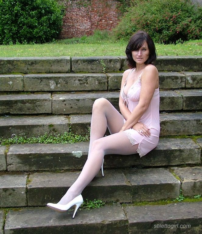 Stiletto girl in stockings and high heels outdoors #72699188