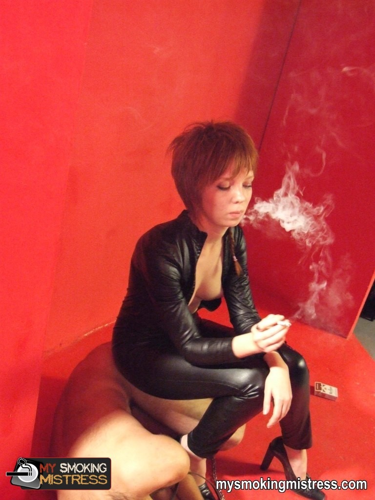 Smoking short haired lady in latex outfit kinkily uses her slave as an ashtray #72153877