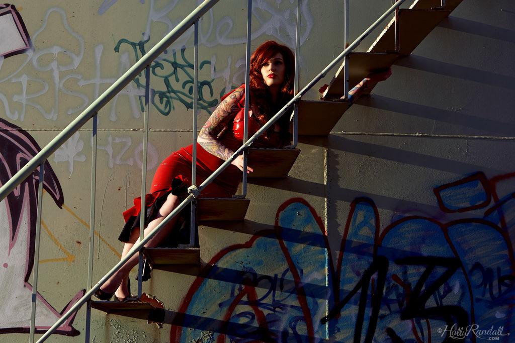 Vanessa Lake, rousse et alternative, se déshabille sur des escaliers en métal à l'extérieur.
 #60129883
