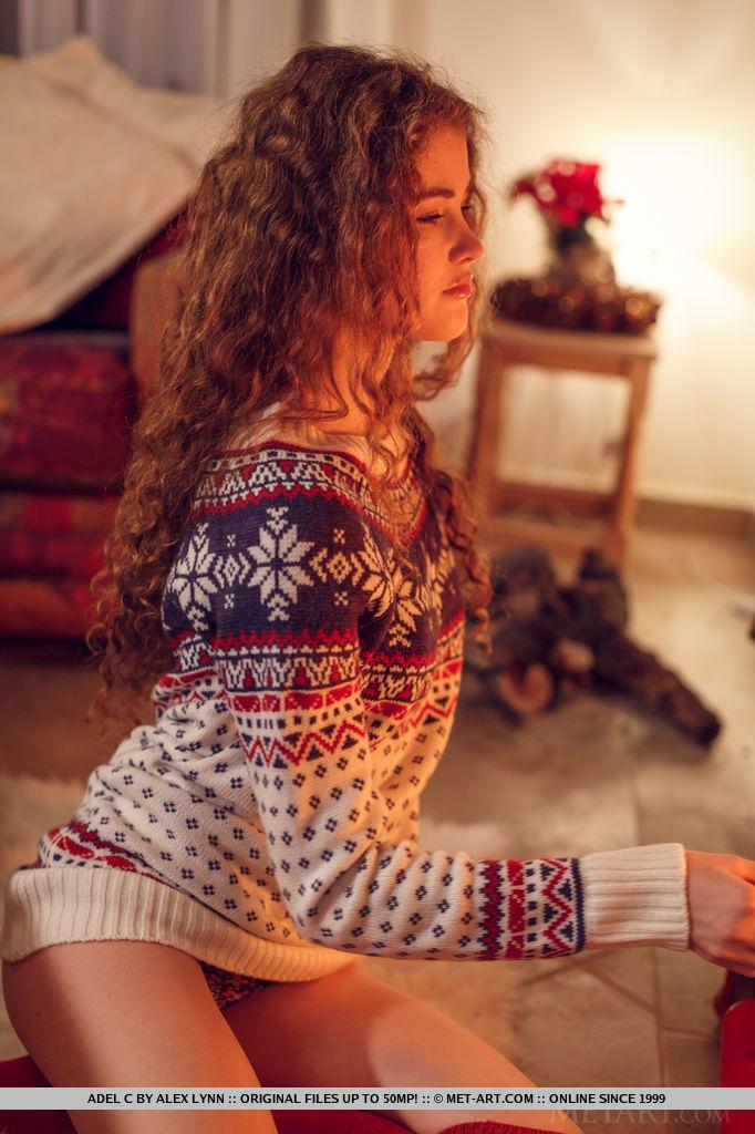 Brunette teen Adel C curls up by the fireplace for the holidays #52897893