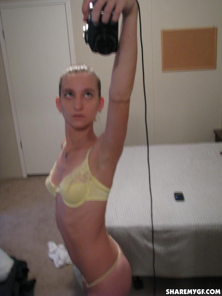 Skinny girlfriend takes selfshot pictures in the mirror of her perky tits in a yellow lace bra #60790264
