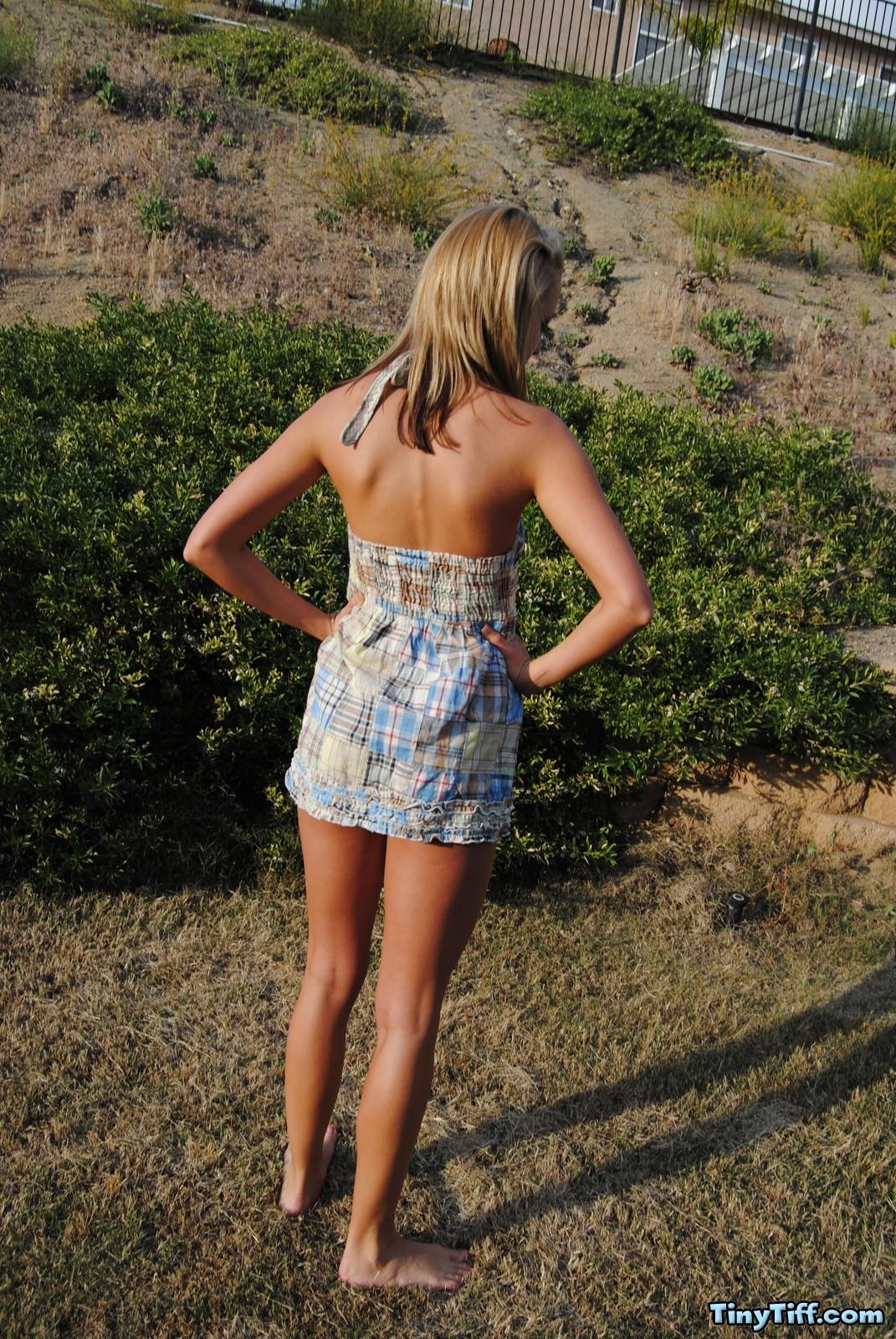 Tiff is outdoors removing her summer dress #58924629
