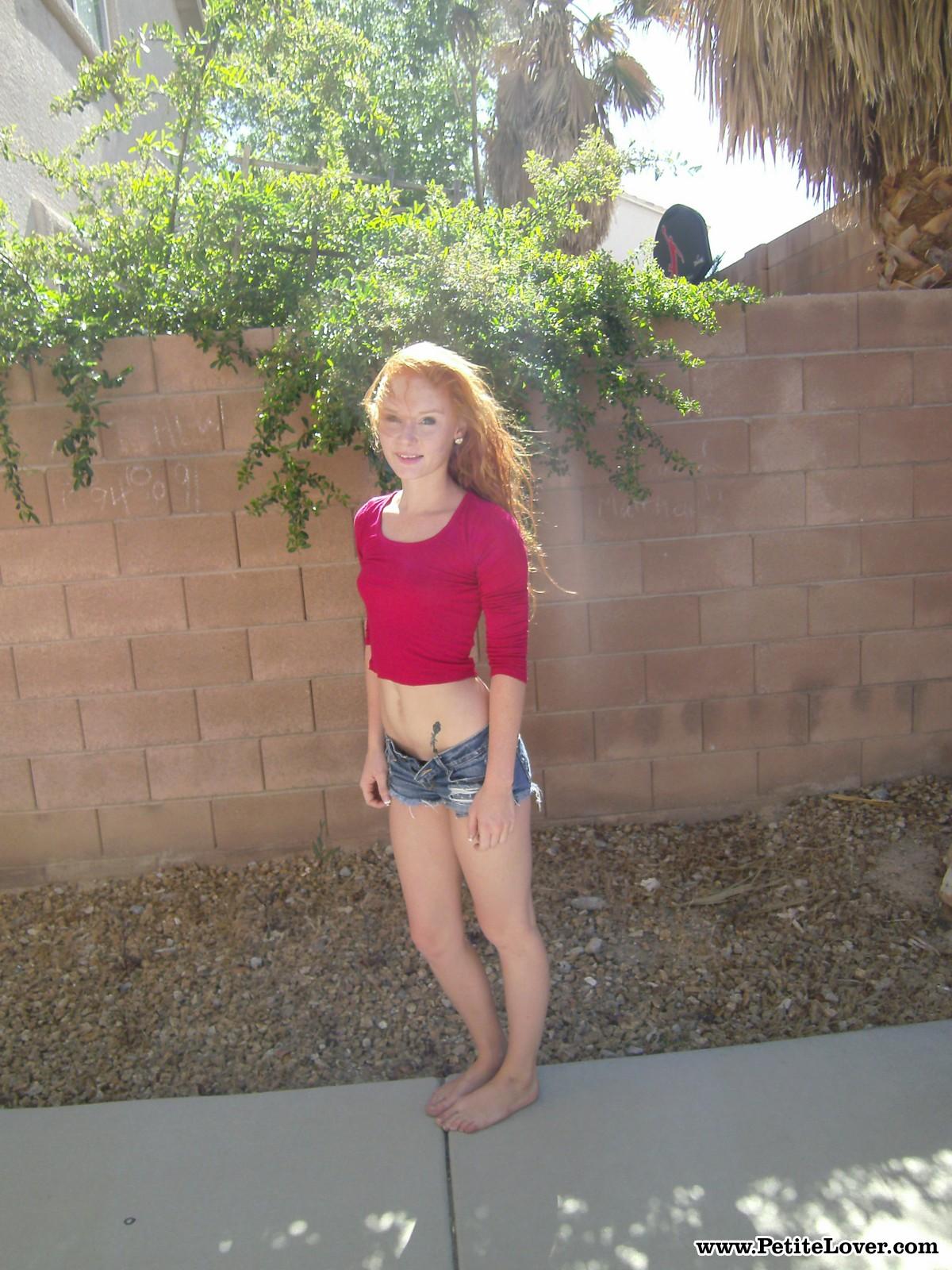Redhead teen Alex Tanner flashes her tight body for you in the backyard