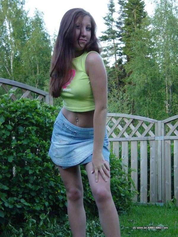 Sexy brunette cutie wearing a mini skirt posing in the garden #60658132