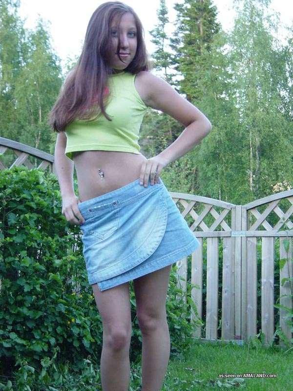 Sexy brunette cutie wearing a mini skirt posing in the garden #60658146