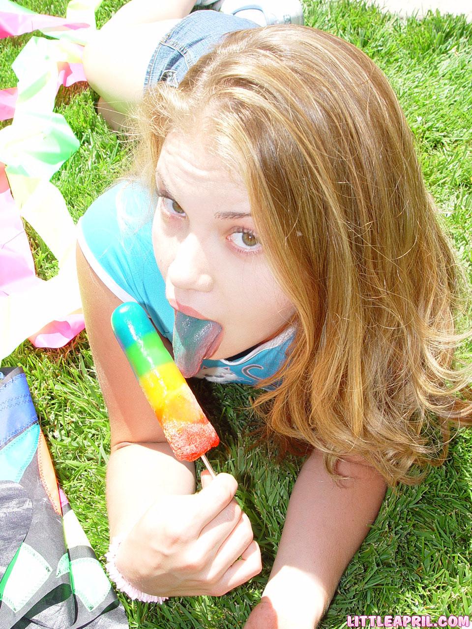 Little April teases with a popsicle before shoving her hands down her panties #58992955