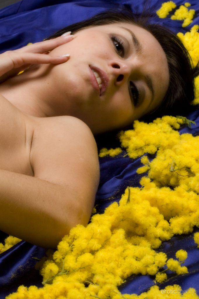 Brunette model Nicollet strips naked with yellow flower buds #60363215