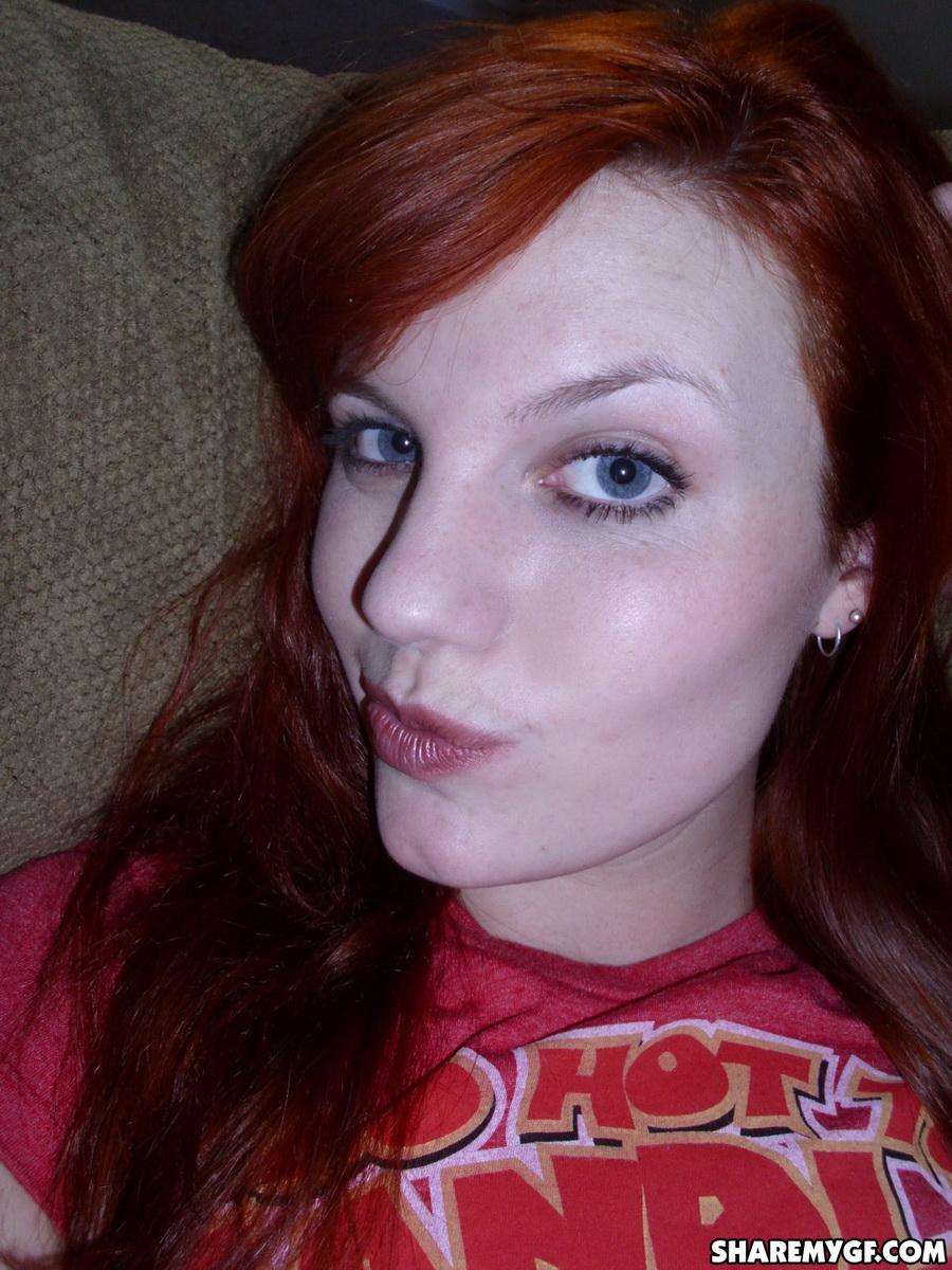 Redhead girlfriend takes selfshot pictures on the couch #60791136