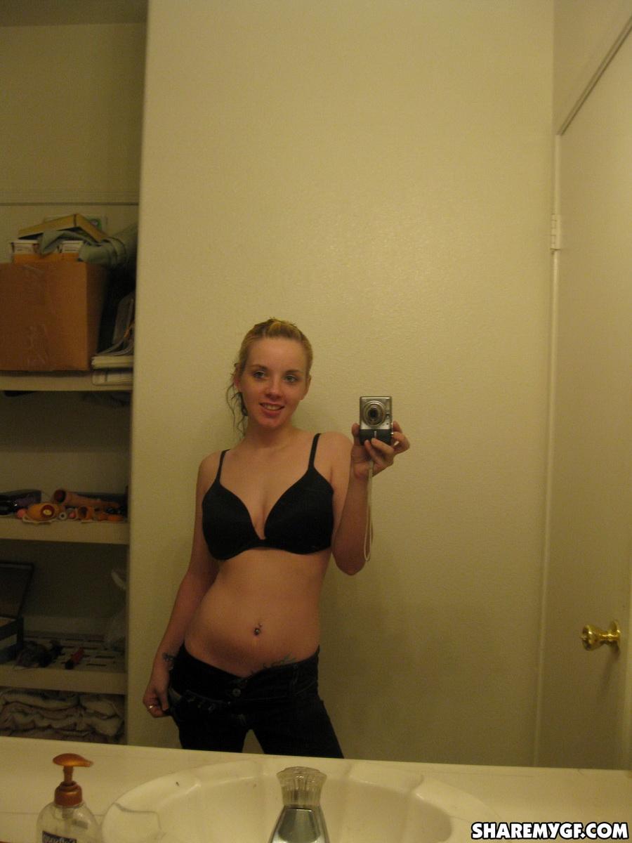 かわいいブロンドの彼女が裸になって、ピアスをした乳首を鏡に映して自撮りする
 #60791279