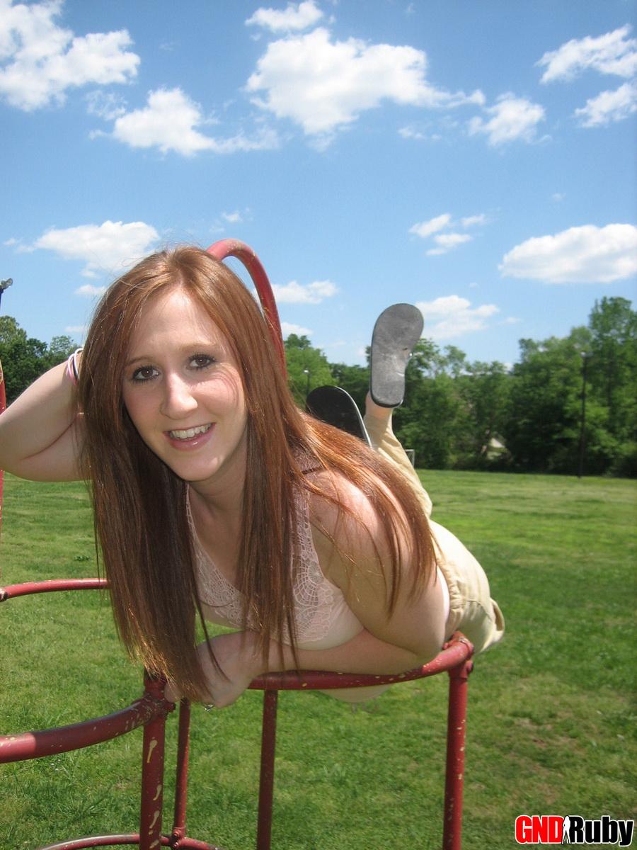 Cute ginger teen Ruby flashes her perky tits at the park while playing on the jungle gym #59948731