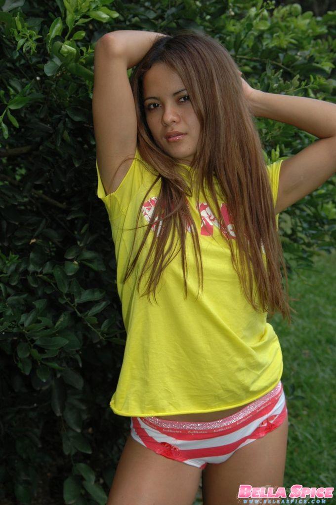 Pictures of a latina teen showing her tits and ass in the grass