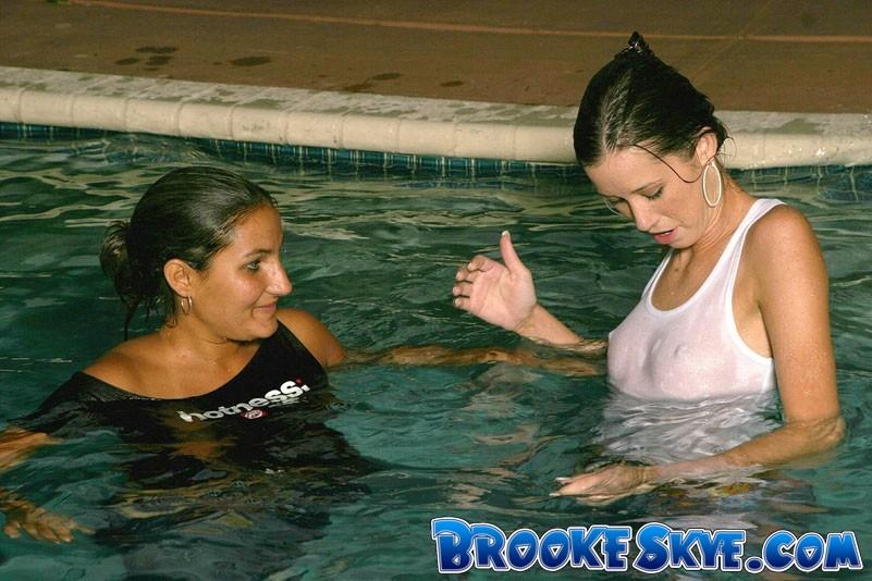 Brooke plays in the pool at night with a friend #53558079