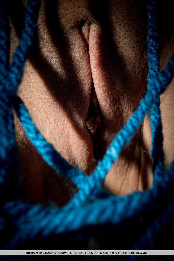 A tangled mess of blue ropes envelop Irena's body as she masturbates on top of the cushioned sofa. #54903446
