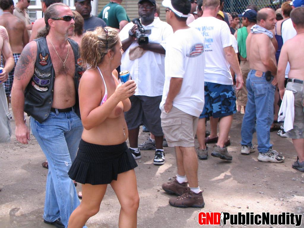 Strippers showing their skills off at an outdoor public nudity party #60506911