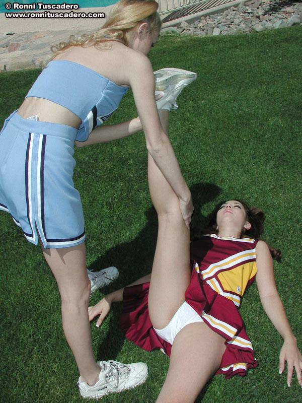 Pictures of two teen cheerleaders practicing their moves outside #59876149