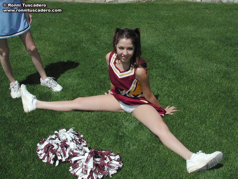 Pictures of two teen cheerleaders practicing their moves outside #59876158