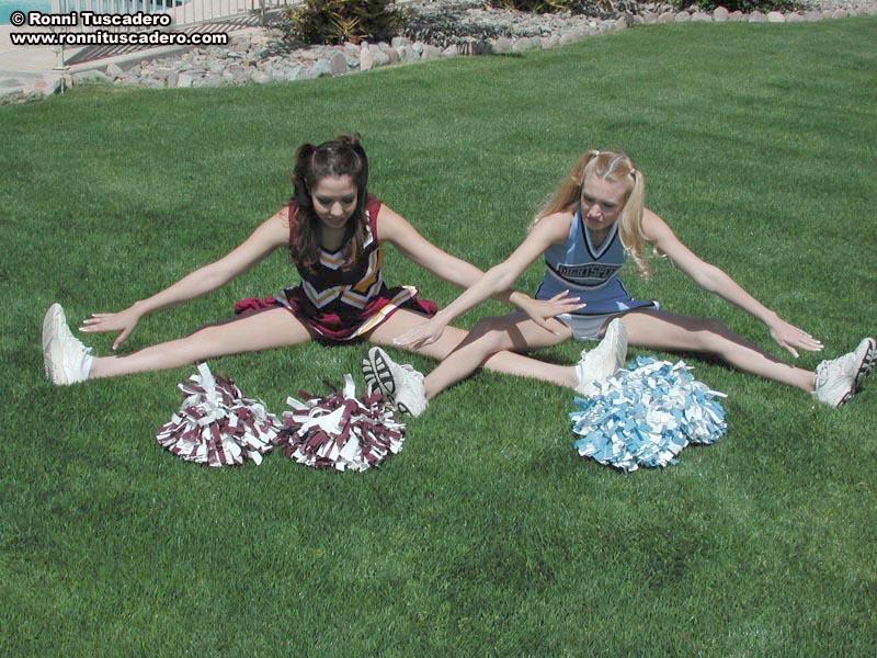 Pictures of two teen cheerleaders practicing their moves outside #59876169
