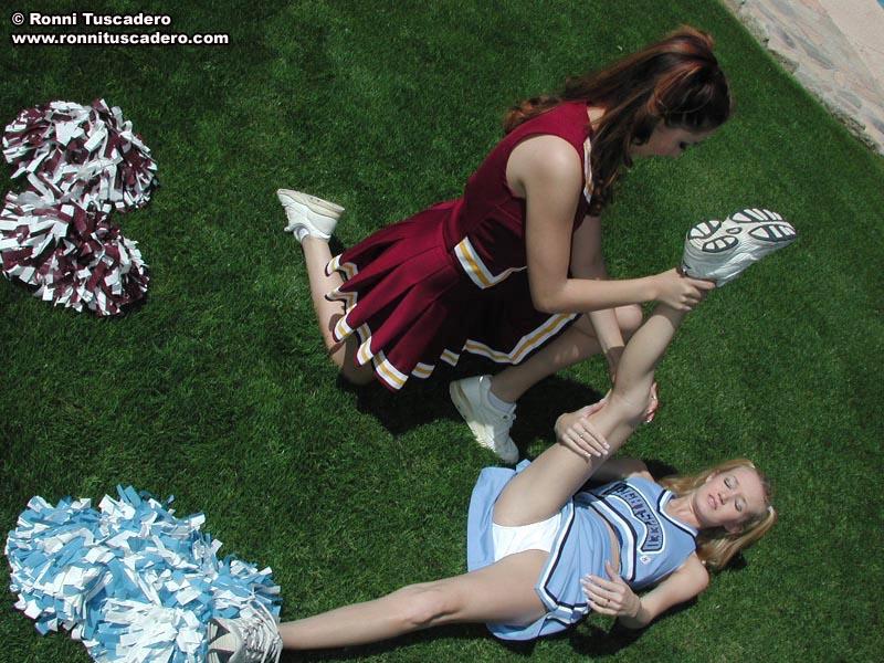 Pictures of two teen cheerleaders practicing their moves outside #59876192