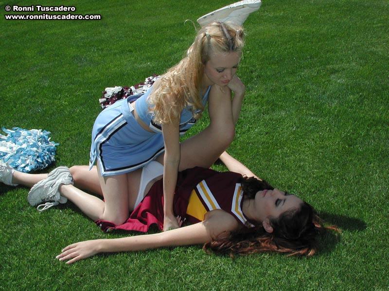 Pictures of two teen cheerleaders practicing their moves outside #59876210