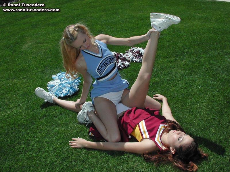 Pictures of two teen cheerleaders practicing their moves outside #59876220
