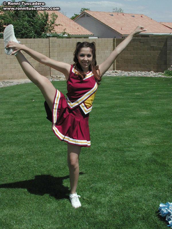 Pictures of two teen cheerleaders practicing their moves outside #59876230