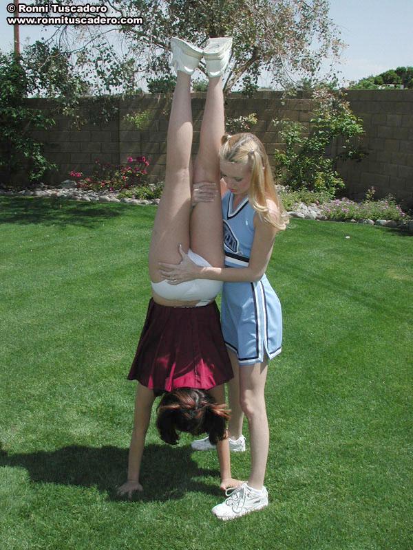 Pictures of two teen cheerleaders practicing their moves outside #59876255