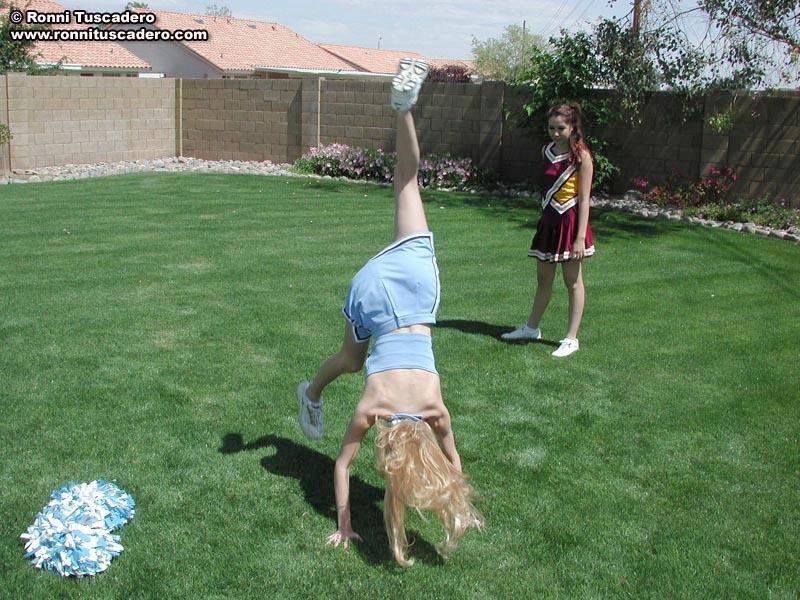 Pictures of two teen cheerleaders practicing their moves outside #59876284