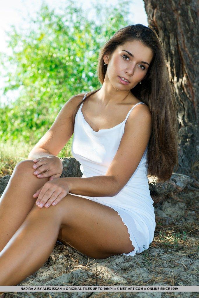 Smoking hot babe Nadira delivers yet another erotic outdoor shoot, strip teasing her white shirt to frolic on the rugged sandy field with wide open poses. #59638494