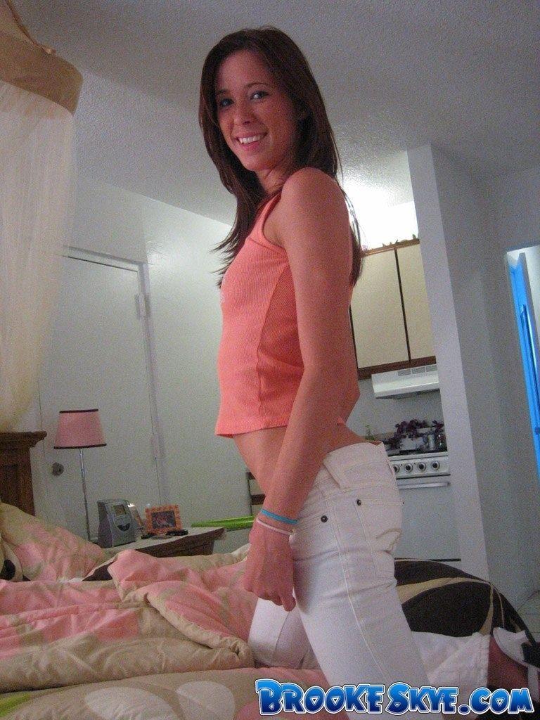 Brooke playing on the bed in white pants #53557434