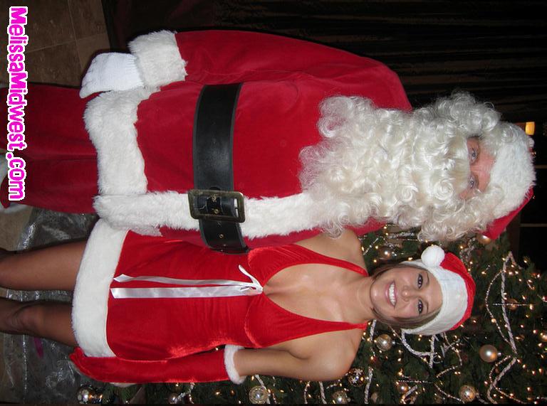 Pictures of Melissa Midwest getting her present from Santa Clause #59493289