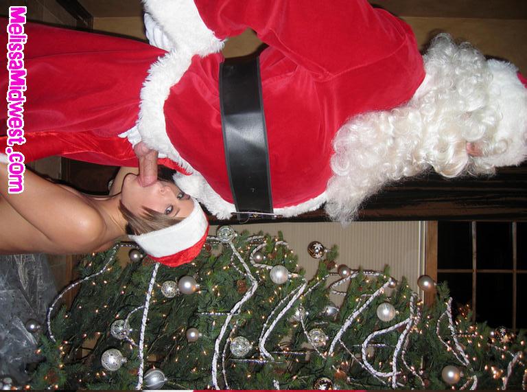 Pictures of Melissa Midwest getting her present from Santa Clause #59493395